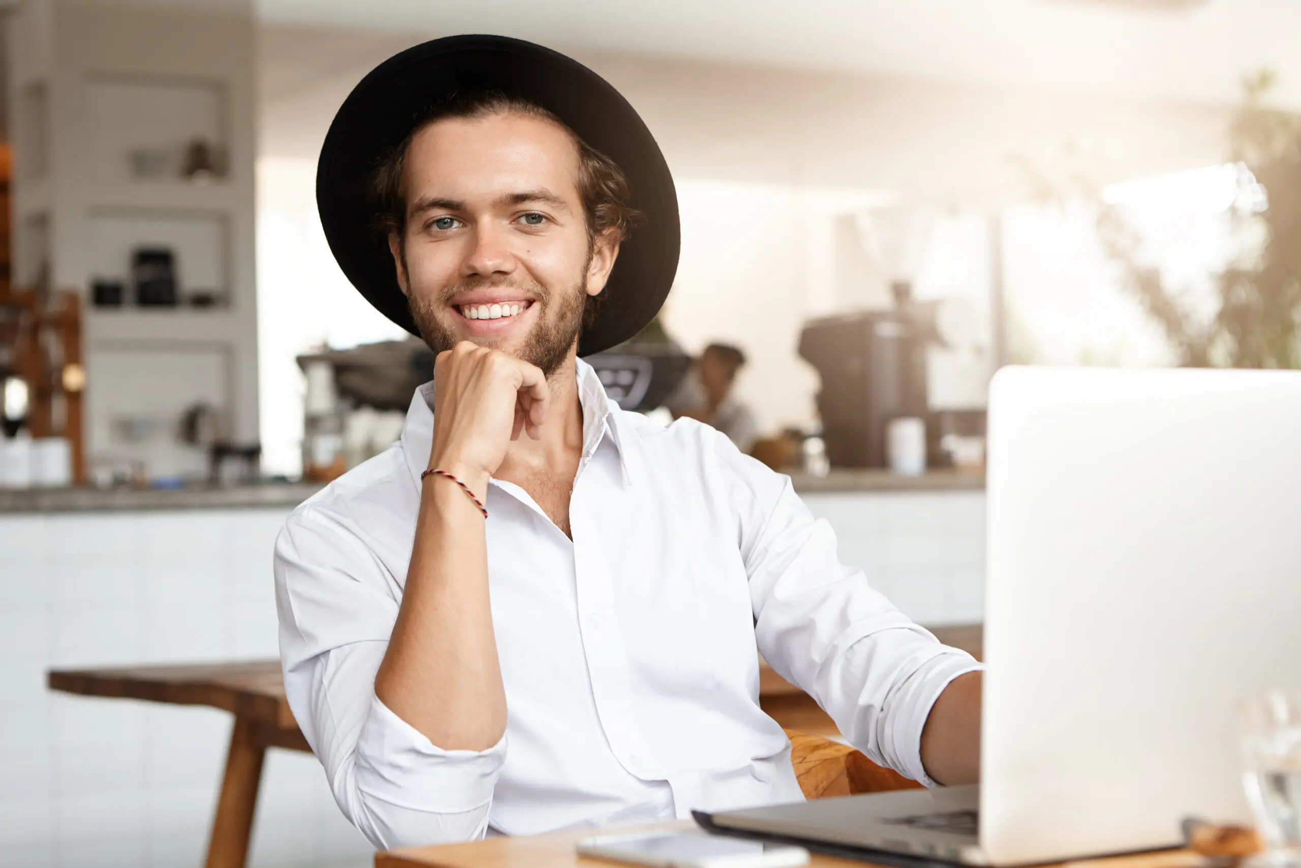 headshot fashionable young man with laptop computer using high speed internet connection lunch cozy cafe interior scaled